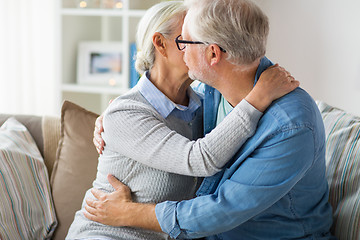 Image showing close up of happy senior couple hugging at home