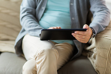 Image showing close up of senior man with tablet pc on sofa