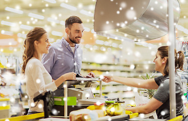 Image showing couple buying food at grocery store cash register