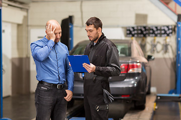 Image showing auto mechanic and customer at car shop