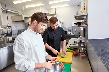 Image showing chef and cook cooking food at restaurant kitchen