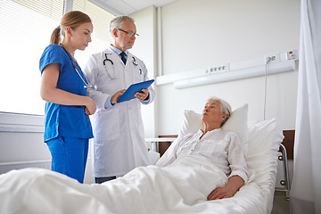 Image showing doctor and nurse visiting senior woman at hospital