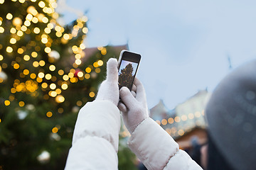 Image showing hands with smartphone photographing christmas tree