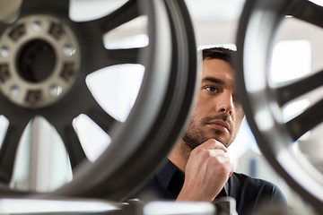 Image showing male customer choosing wheel rims at car service