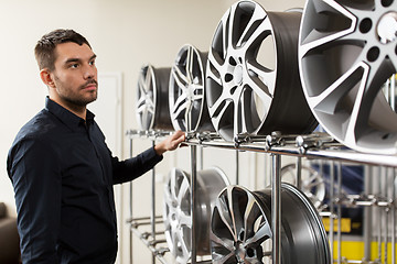 Image showing male customer choosing wheel rims at car service