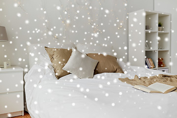 Image showing bedroom with bed and christmas garland at home