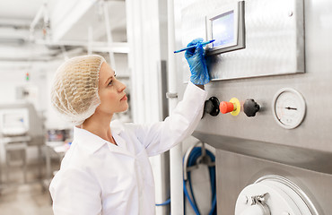 Image showing woman programming computer at ice cream factory