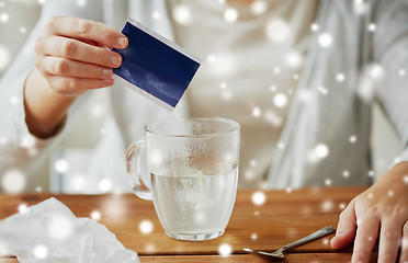 Image showing close up of ill woman pouring medication into cup