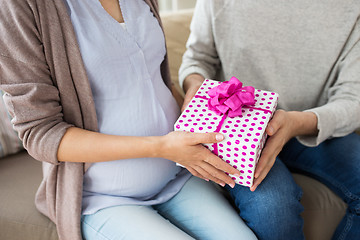 Image showing close up of man giving present to pregnant wife