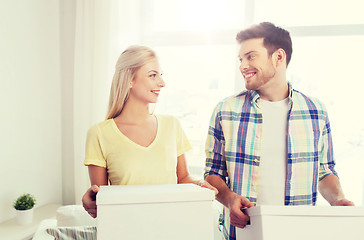 Image showing smiling couple with big boxes moving to new home