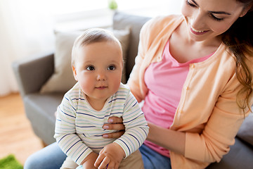 Image showing happy young mother with little baby at home