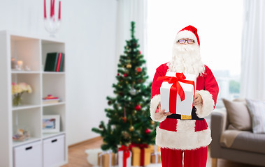 Image showing santa claus with christmas gift at home