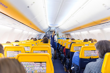 Image showing Stewardess serving passangers on Ryanair airplane flight on 14th of December, 2017 on a flight from Trieste to Valencia.