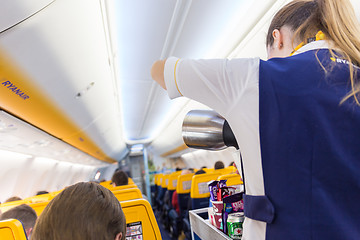 Image showing Stewardess serving passangers on Ryanair airplane flight on 14th of December, 2017 on a flight from Trieste to Valencia.