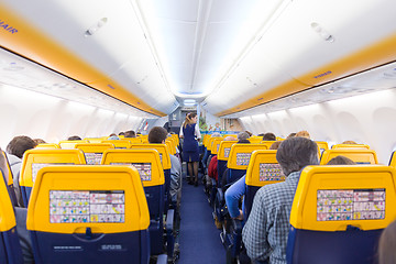 Image showing Stewardess serving passangers on Ryanair airplane flight on 14th of December, 2017 on a flight from Trieste to Valencia.