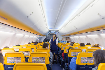 Image showing Stewardess serving passangers on Ryanair airplane flight on 14th of December, 2017 on a flight from Trieste to Valencia.