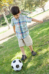 Image showing Cute Young Boy Playing with Soccer Ball Outdoors in the Park.