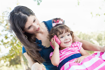 Image showing Mixed Race Mother and Cute Baby Daughter Playing with Cell Phone