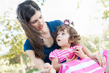 Image showing Mixed Race Mother and Cute Baby Daughter Playing with Cell Phone