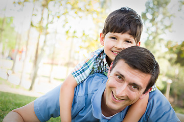 Image showing Mixed Race Father and Son Playing Together in the Park.