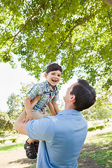 Image showing Happy Caucasian Father and Son Playing Together in the Park.