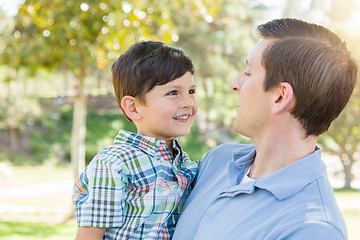 Image showing Happy Caucasian Father and Son Playing Together in the Park.