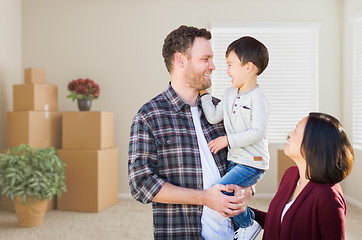 Image showing Young Mixed Race Caucasian and Chinese Family Inside Empty Room 