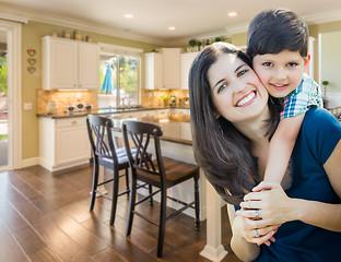 Image showing Young Mother and Son Inside Beautiful Custom Kitchen.