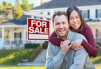 Image showing Mixed Race Caucasian and Chinese Couple In Front of For Sale Rea