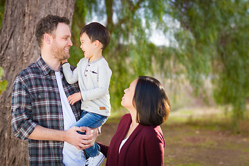 Image showing Young Mixed Race Caucasian and Chinese Family Portrait Outdoors.