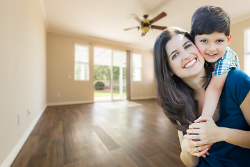 Image showing Young Mother and Son Inside Empty Room with Wood Floors.