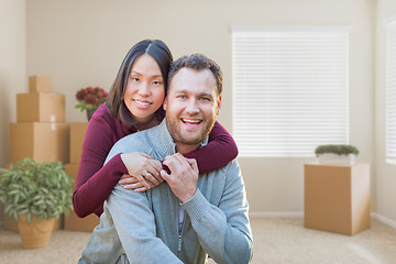 Image showing Mixed Race Caucasian and Chinese Couple Inside Empty Room with M