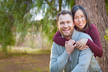 Image showing Mixed Race Caucasian and Chinese Couple Portrait Outdoors.