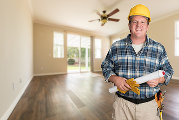 Image showing Contractor With Plans and Hard Hat Inside Empty Room with Wood F