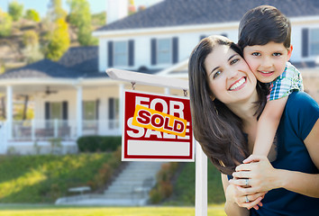 Image showing Young Mother and Son In Front of Sold For Sale Real Estate Sign 