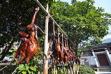 Image showing Rows of cured meat hanging to dry