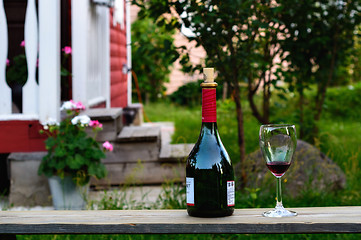 Image showing Bottle and a wineglass of wine.
