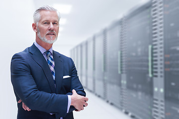 Image showing Senior businessman in server room