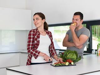 Image showing Young handsome couple in the kitchen