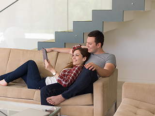 Image showing couple relaxing at  home with tablet computers