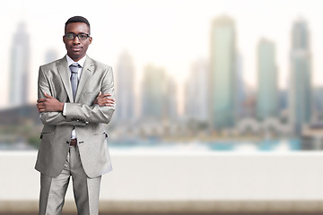 Image showing Young black businessman in front of the big city