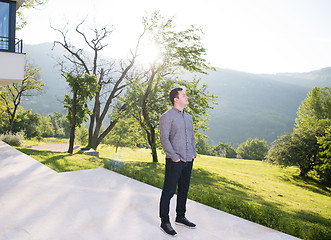 Image showing man in front of his luxury home villa