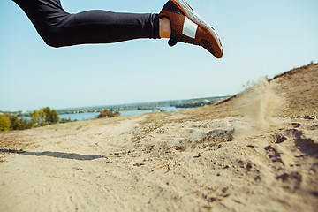 Image showing Running sport. Man runner sprinting outdoor in scenic nature. Fit muscular male athlete training trail running for marathon run.