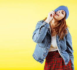 Image showing lifestyle people concept: pretty young school teenage girl having fun happy smiling on yellow background