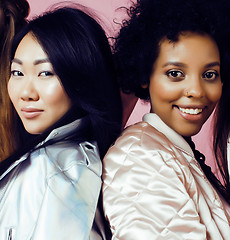 Image showing different nation girls with diversuty in skin, hair. Asian, scandinavian, african american cheerful emotional posing on pink background, woman day celebration, lifestyle people concept