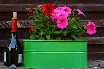 Image showing Flowers and a bottle of wine.