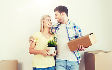 Image showing smiling couple with big boxes moving to new home