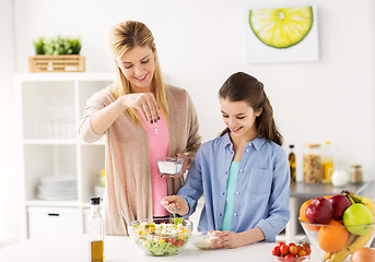 Image showing happy family cooking salad at home kitchen