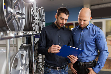 Image showing customer and salesman at car service or auto store