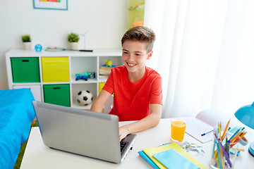 Image showing student boy typing on laptop computer at home